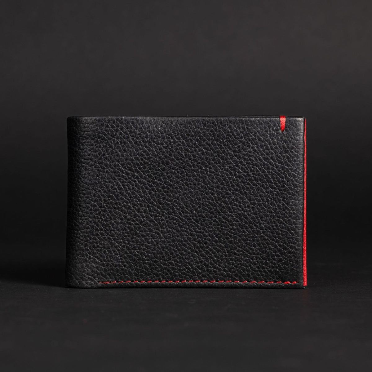 The Diablo dollar size black leather wallet with red stitching