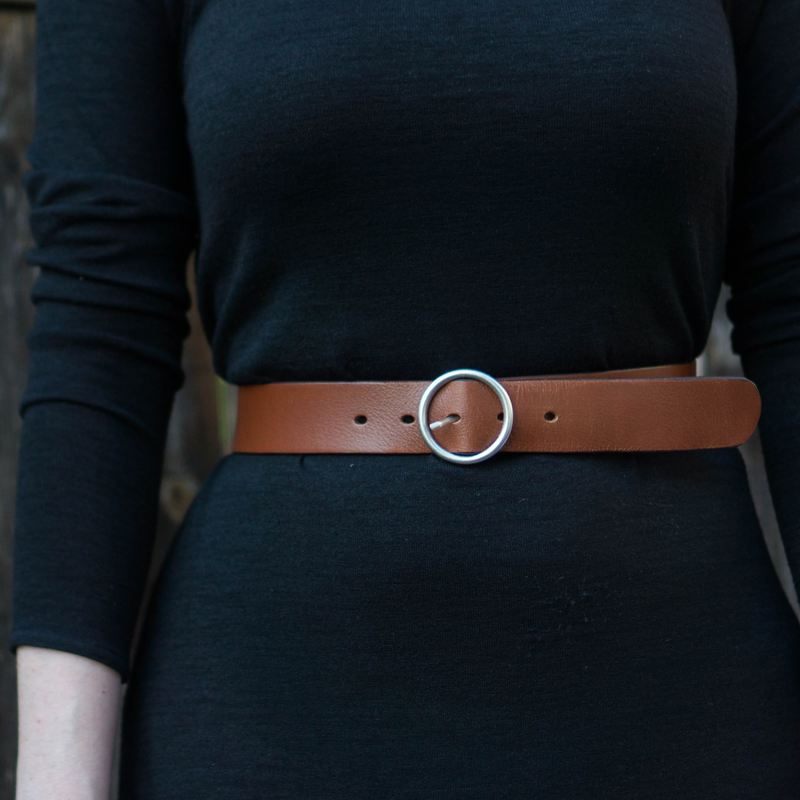 Women's black leather belt with silver belt buckle. 