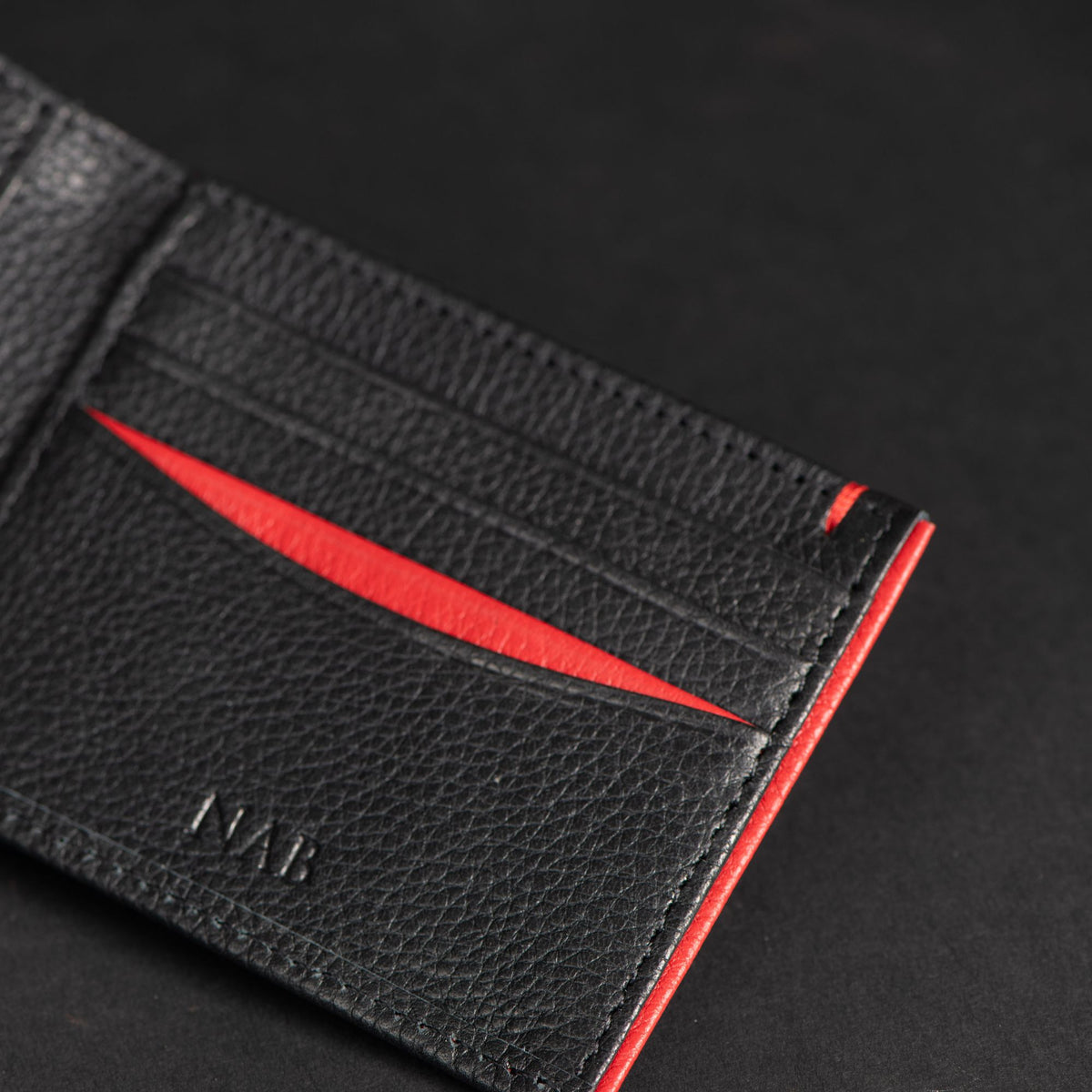 The Diablo dollar size black leather wallet with red stitching