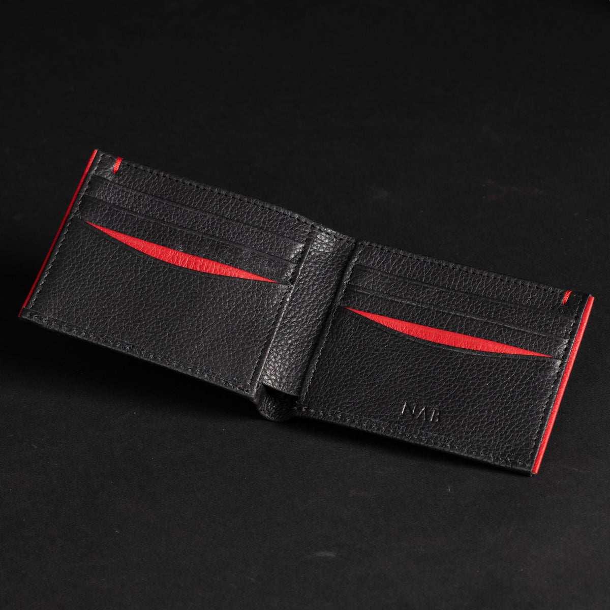 The Diablo dollar size black leather wallet with red stitching