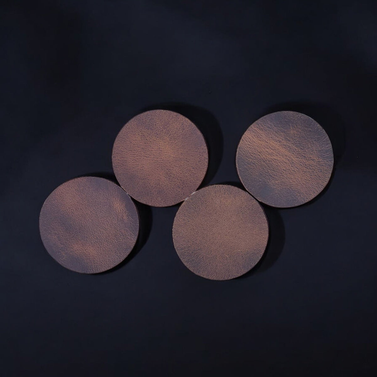 Round distressed leather coasters in cognac