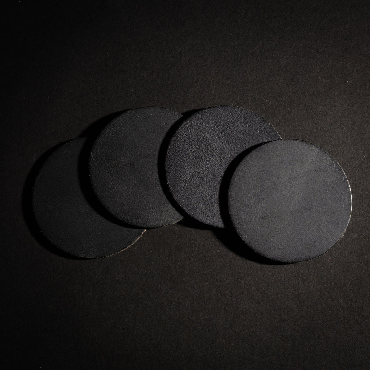 Round distressed leather coasters in black