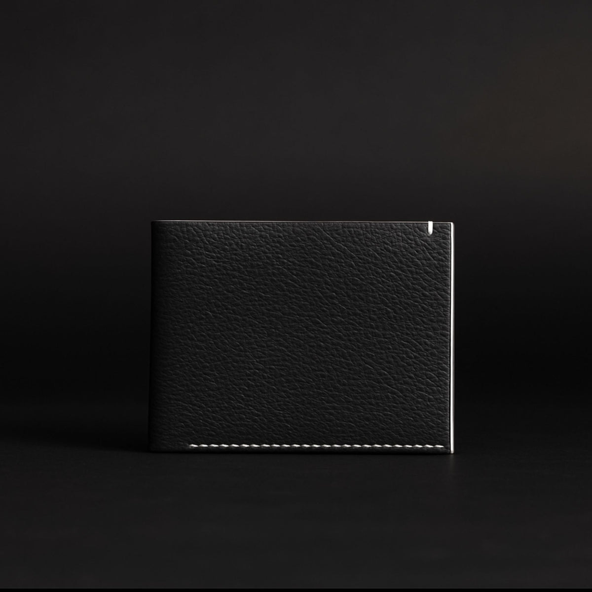 The Diablo dollar size black leather wallet with red stitching