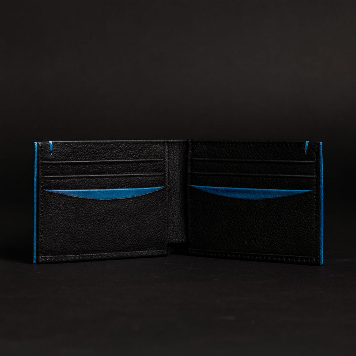 The Diablo dollar size black leather wallet with red stitching