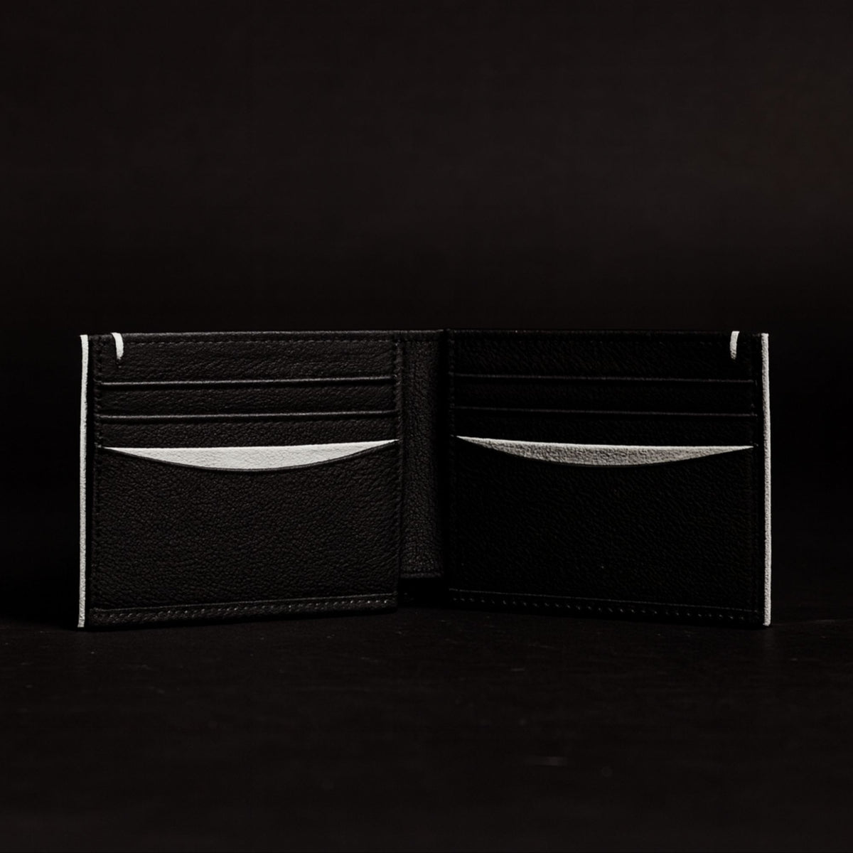 The Diablo dollar size black leather wallet with red stitching