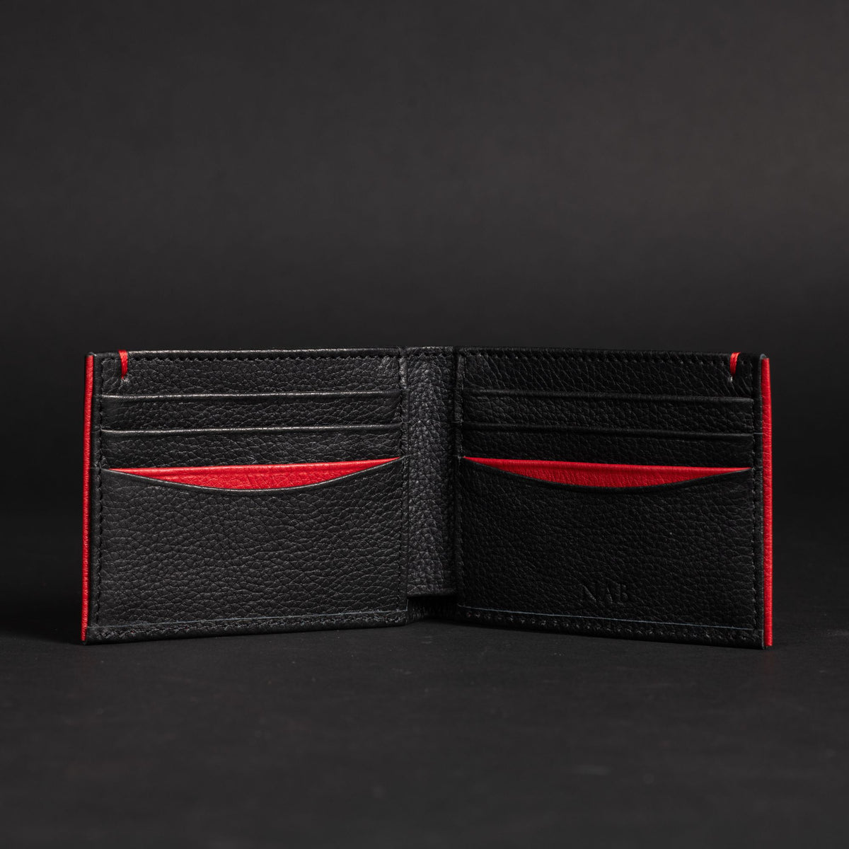 The Diablo dollar size black leather wallet with red stitching