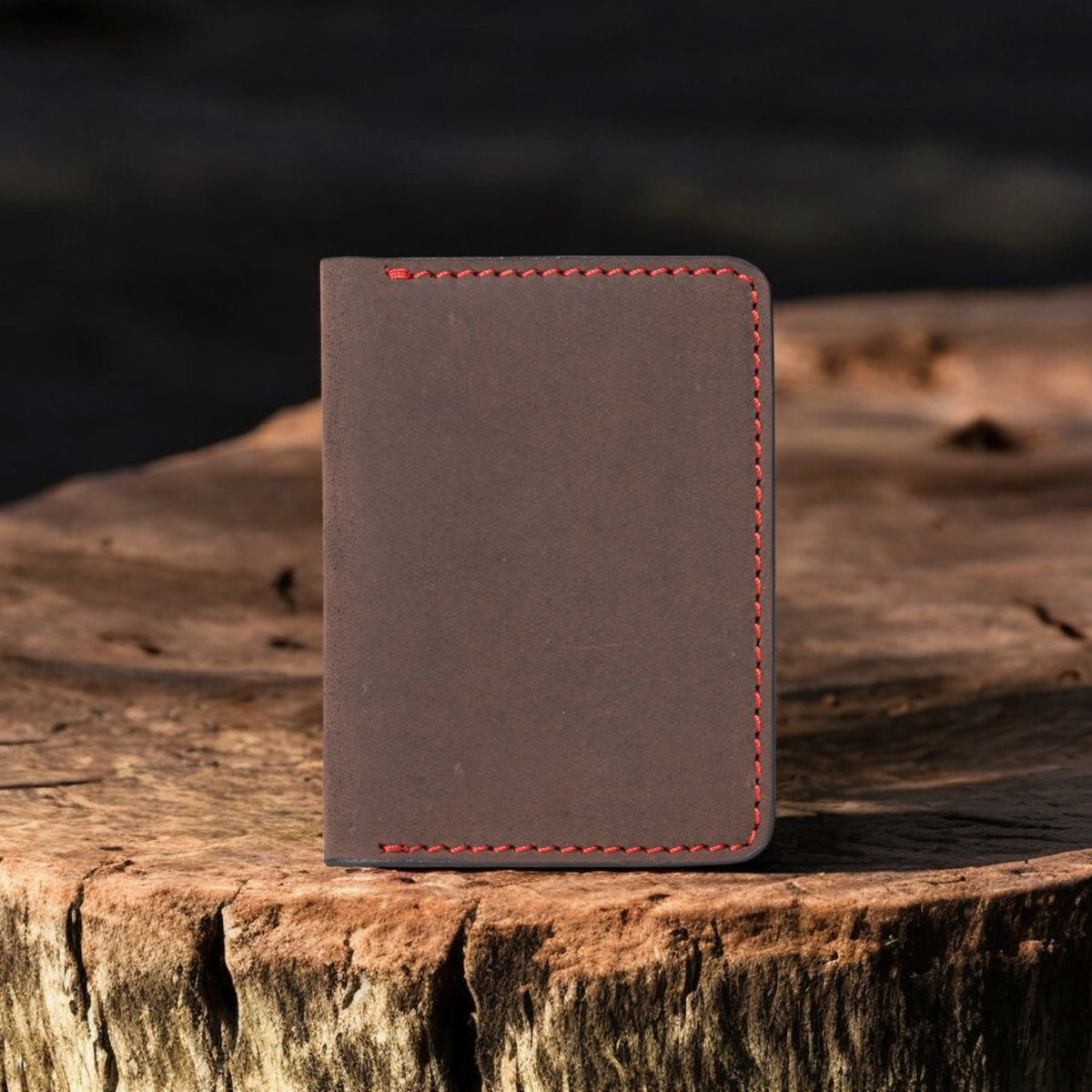 Brown full-grain leather card holder with red hand stitching
