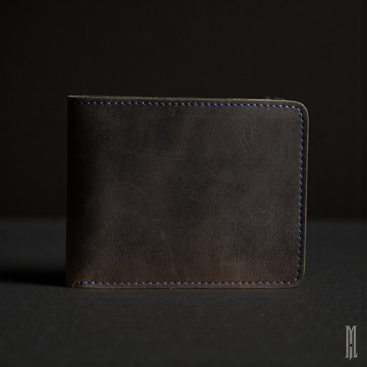 The Poseidon black full-grain leather wallet with blue stitching