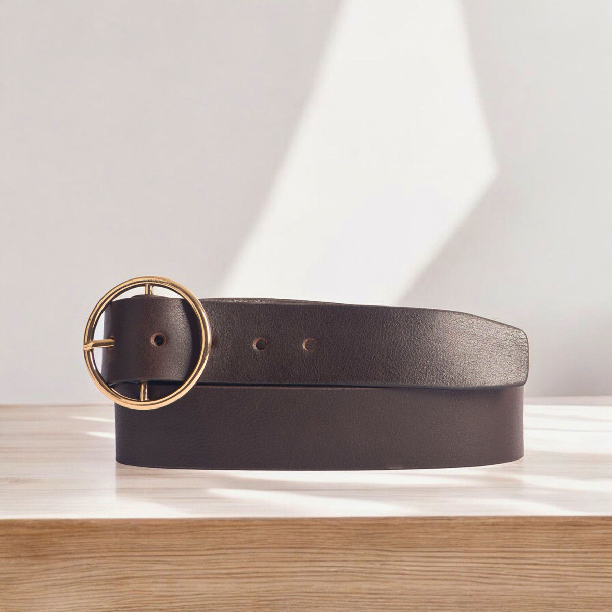 Orla black leather dress belt with large gold circle buckle