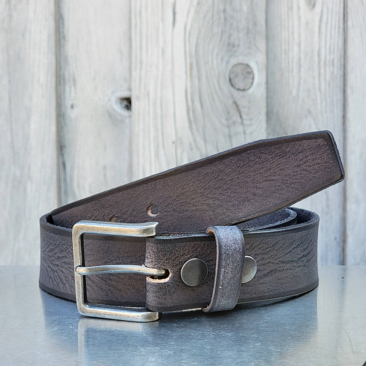 The Mountain women's leather belt with charred edges in grey